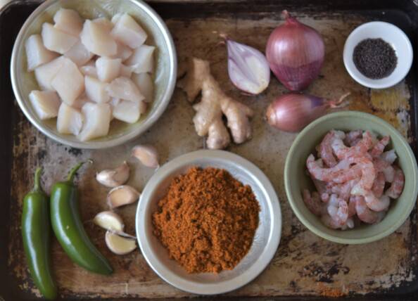 ingredients for south Indian seafood curry layed out on an aluminum tray